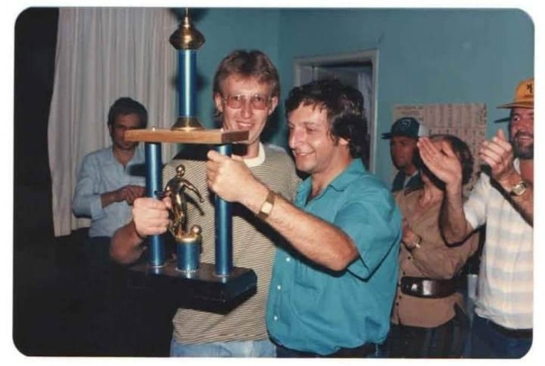 || Rogério Weber recebendo o troféu de classificação, provavelmente de futebol de salão, pela Assemar,  competição realizado durante a 1ª Oktoberfest, em outubro de 1987. 
Imagem: Acervo Rogério Weber. 