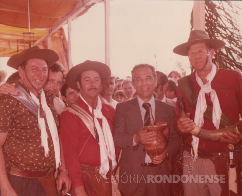 18ª página - governador Neu Braga tomando um cuia de chimarrão com uma equipe de assadores.